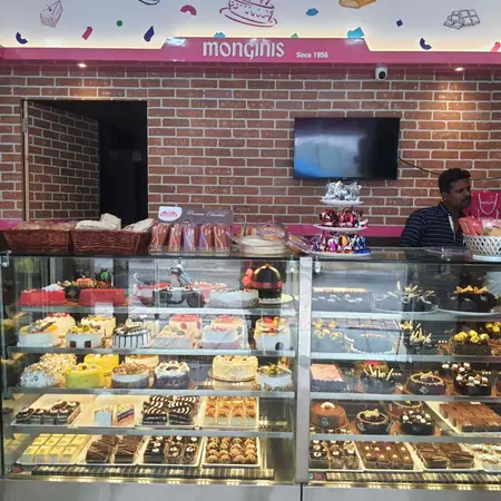 Brick-wall shop interior with pastries and cakes in a glass counter